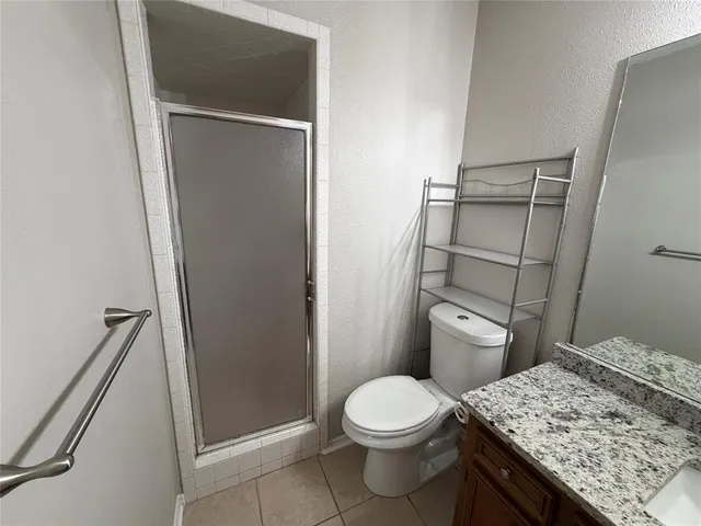 a view of an empty room and a ceiling fan