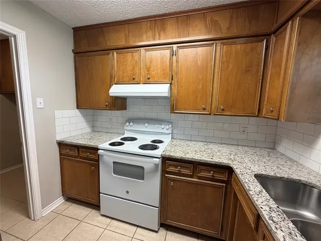 a kitchen with a stove and a sink