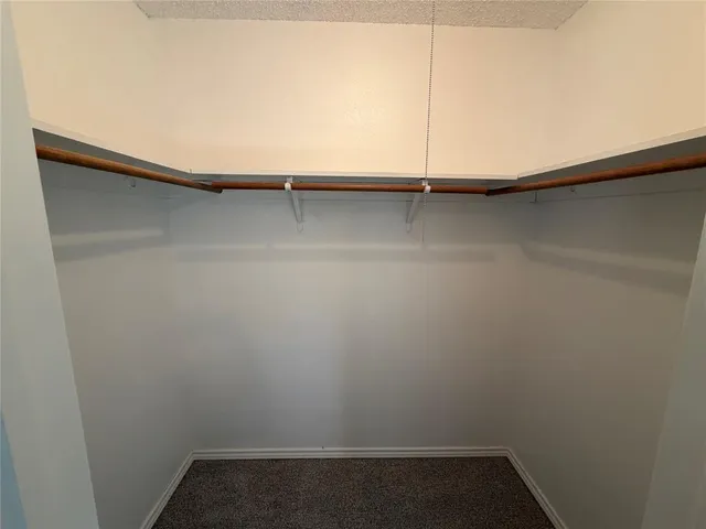 a bathroom with a granite countertop toilet and a sink