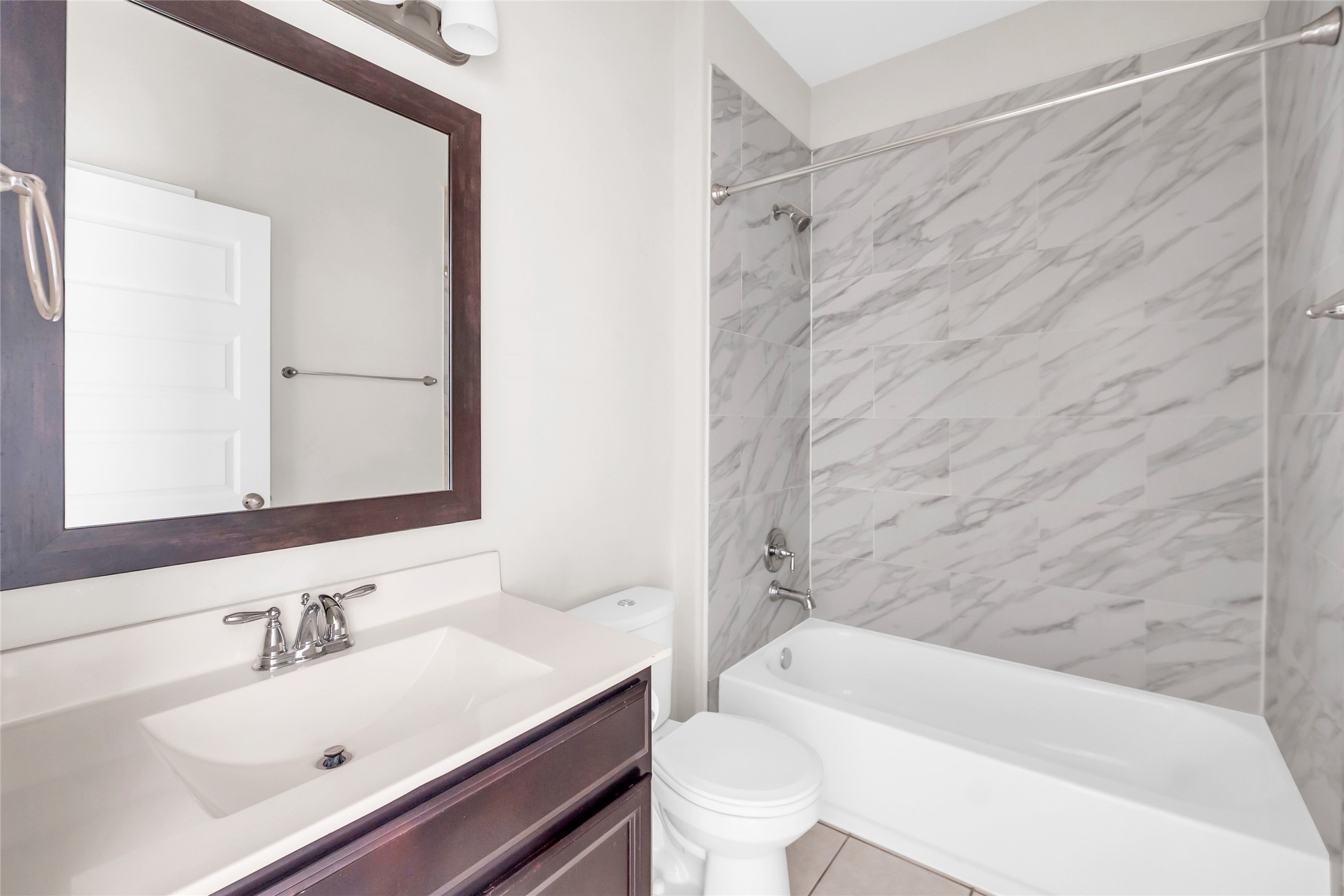 22519 Birch Ridge Meadow Drive Spring, TX 77389 - Photo 12 of 17 a bathroom with a sink mirror toilet and bathtub