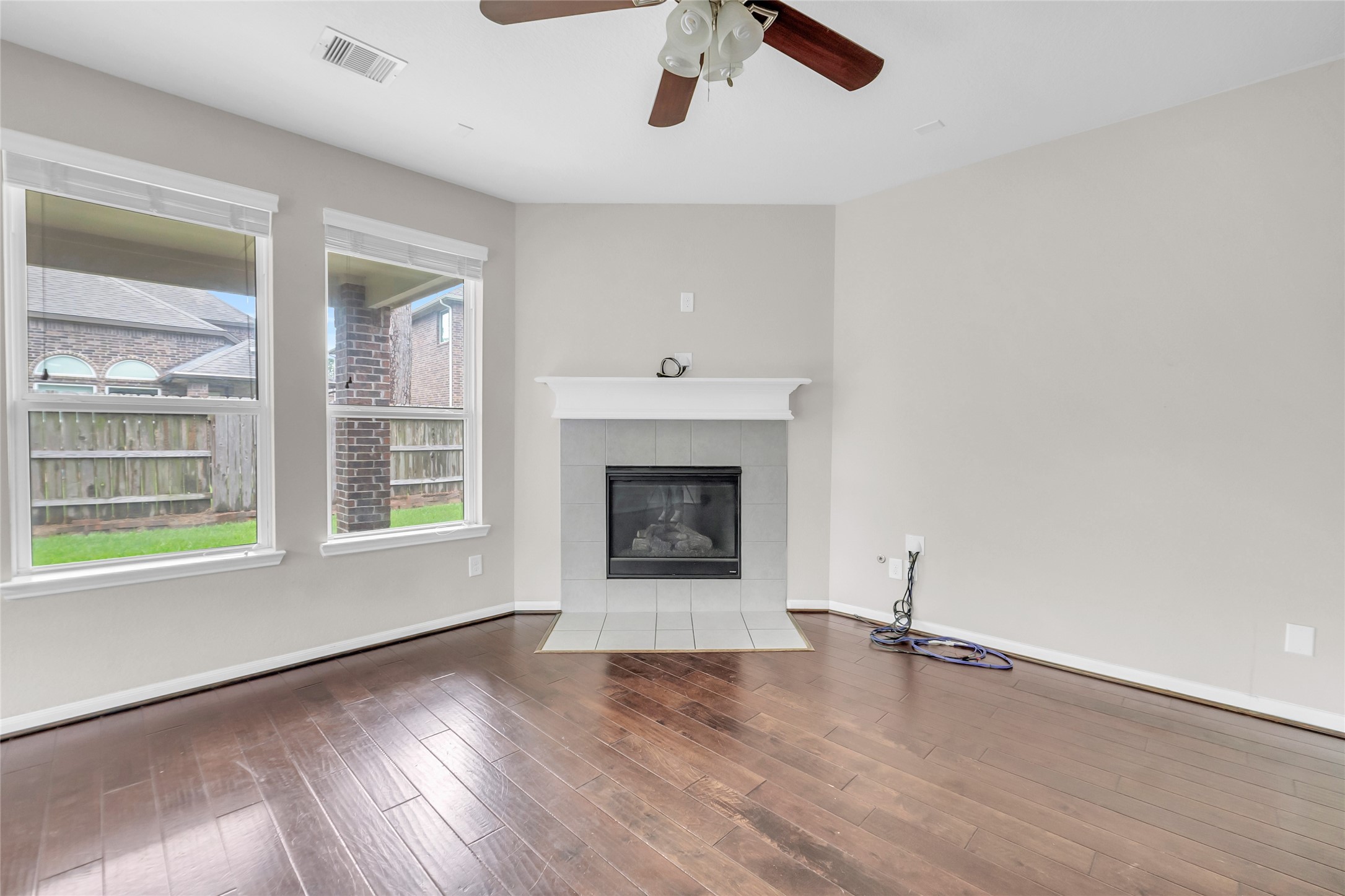 22519 Birch Ridge Meadow Drive Spring, TX 77389 - Photo 5 of 17 wooden floor fireplace and windows in an empty room