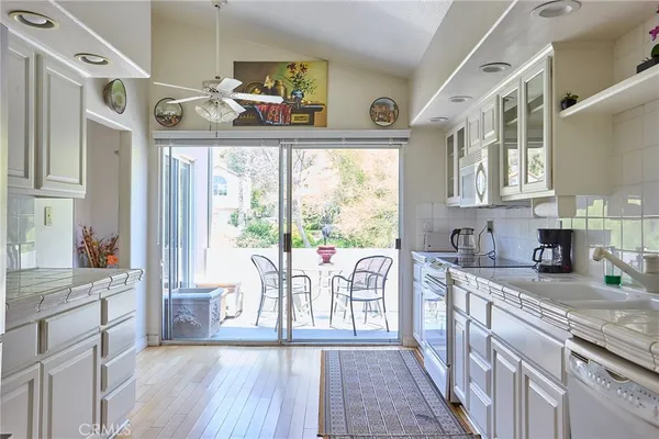 a kitchen with stainless steel appliances a refrigerator sink and cabinets