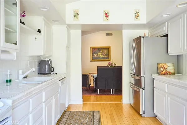 a kitchen with cabinets appliances and a window