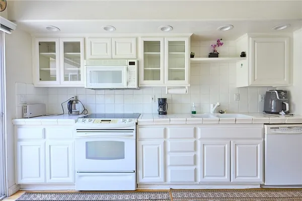a bathroom with a sink vanity mirror and toilet