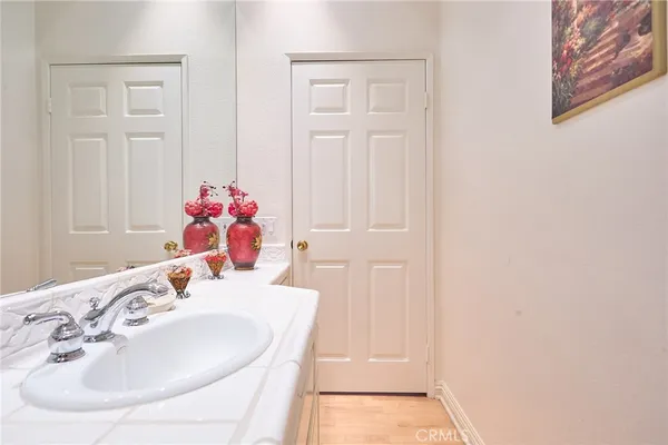 a kitchen with a sink a chandelier and a dining table