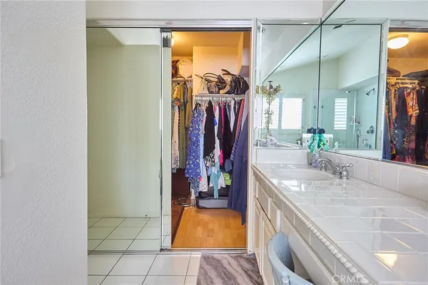 a bathroom with a tub a sink and flowers