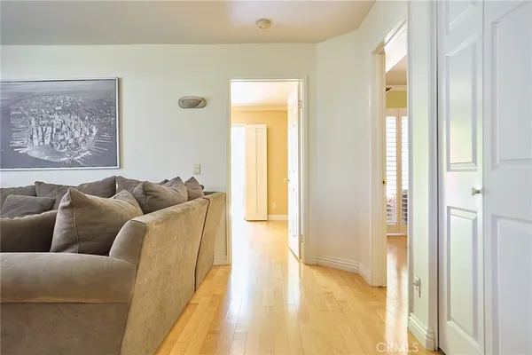 a view of a livingroom with wooden floor and a large window