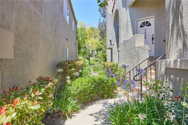 front view of a house with a yard and flowers