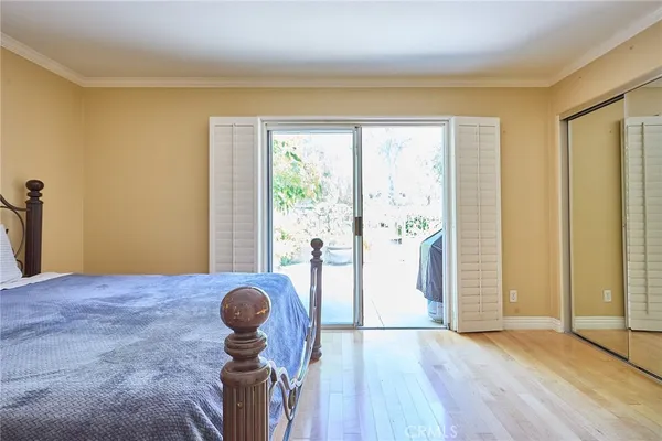 a bedroom with a large bed and a large window