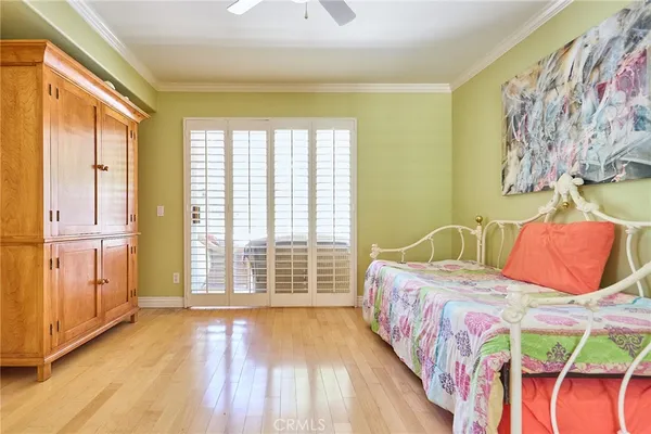 a bedroom with a bed and a painting on the wall