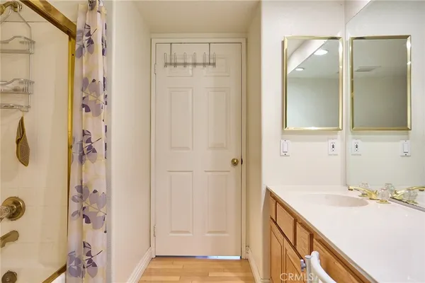a backyard of a house with couches and potted plants