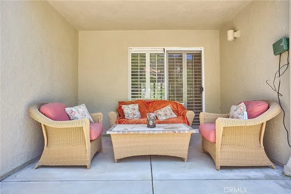 a view of a patio with couches and potted plants