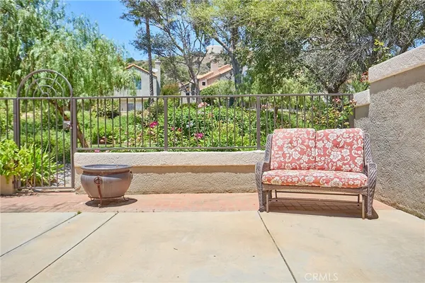 a view of a white house next to a yard and trees