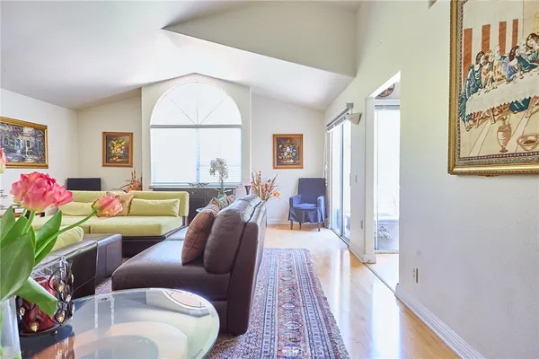 a living room with furniture a fireplace and a large window