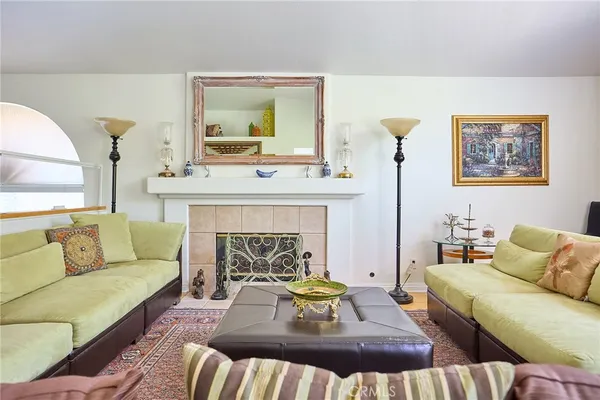 a living room with furniture a table and a large window