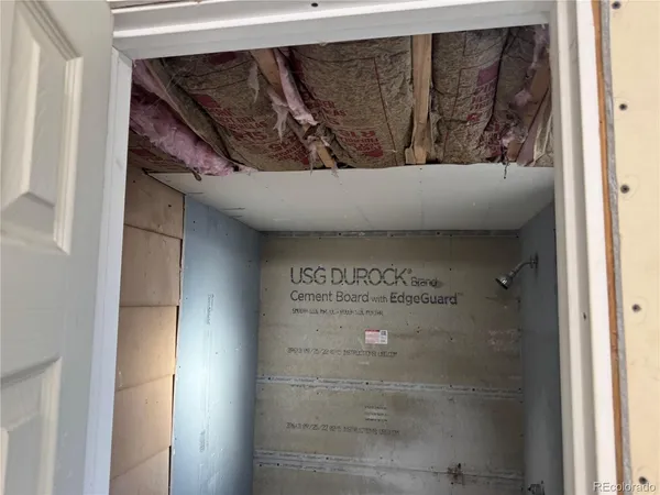 a white toilet sitting next to a small bathroom