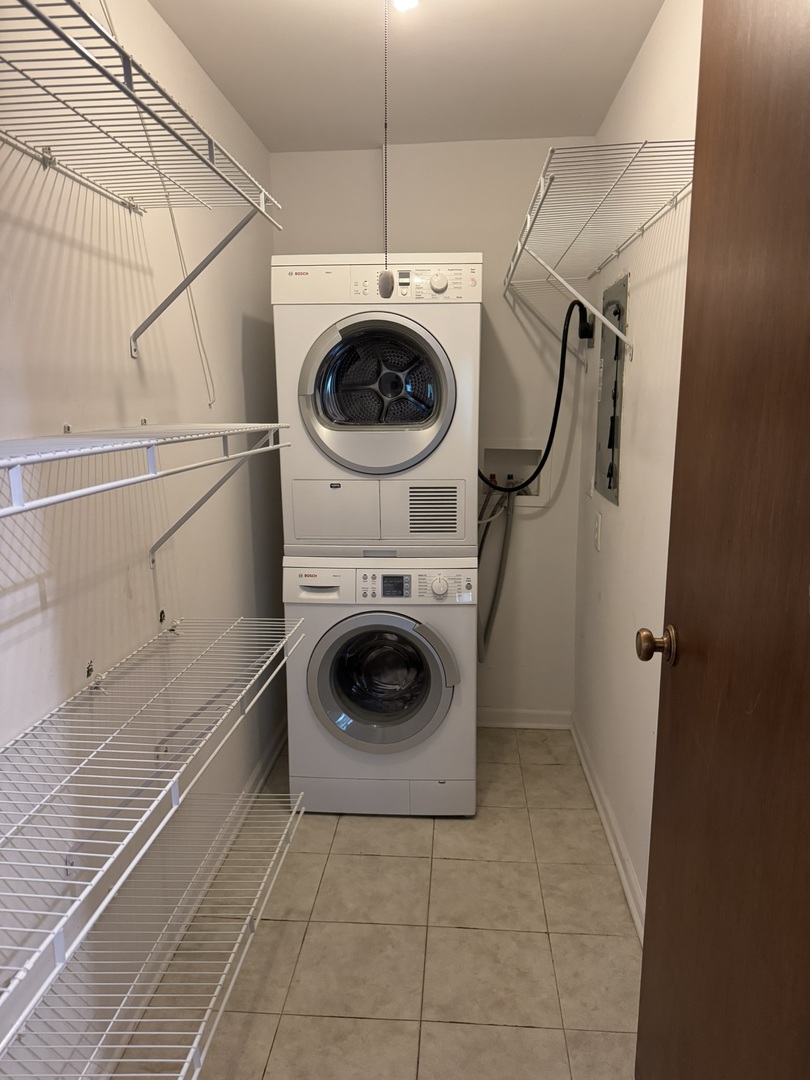 9244 Gross Point Road, Unit 103 Skokie, IL 60077 - Photo 11 of 28 a utility room with dryer and washer