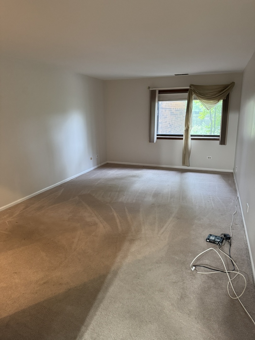 9244 Gross Point Road, Unit 103 Skokie, IL 60077 - Photo 16 of 28 an empty room with a window