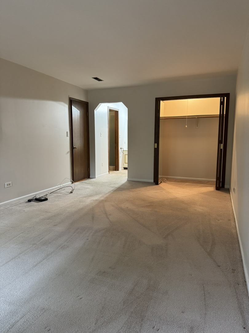 9244 Gross Point Road, Unit 103 Skokie, IL 60077 - Photo 22 of 28 a view of a big room with windows and chandelier