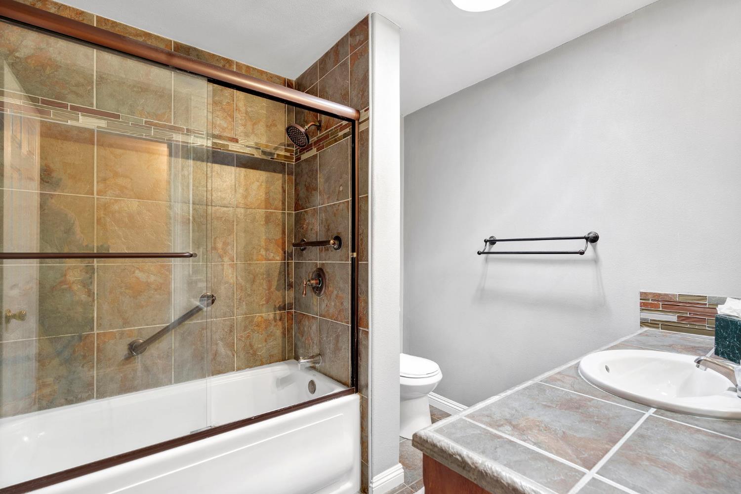 200 Lyons Street Madera, CA 93638 - Photo 23 of 32 a bathroom with a sink and a mirror