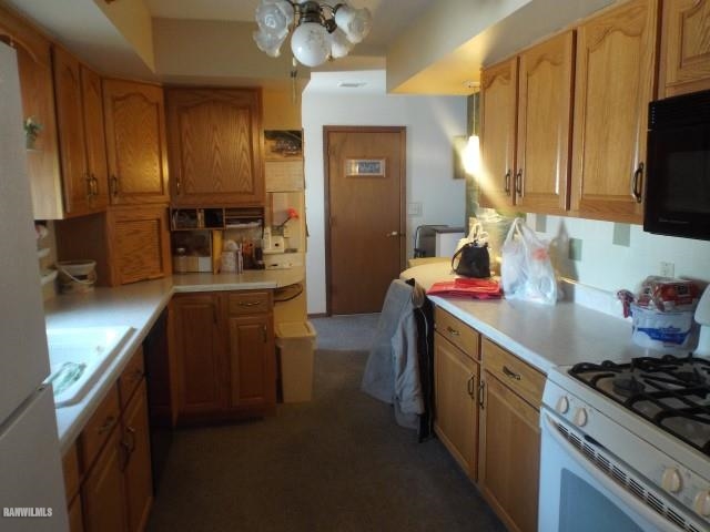 1814 North Rink Road Freeport, IL 61032 - Photo 2 of 14 a kitchen with stainless steel appliances granite countertop a sink stove and refrigerator