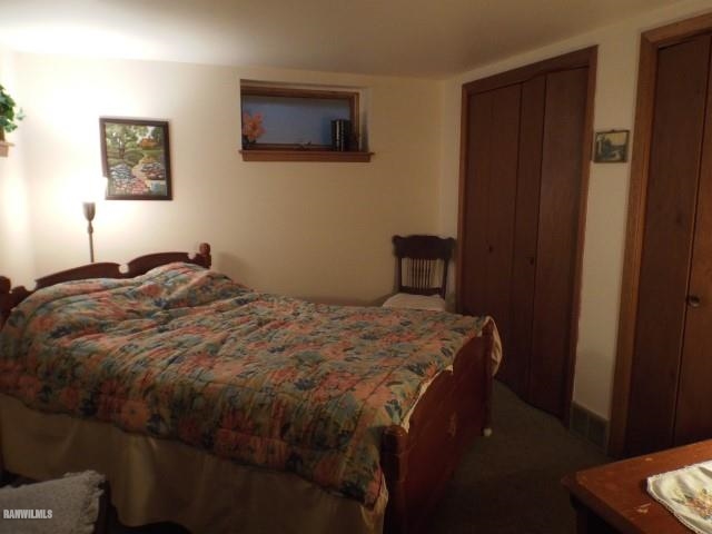 1814 North Rink Road Freeport, IL 61032 - Photo 7 of 14 a bedroom with a bed and a lamp on the dresser