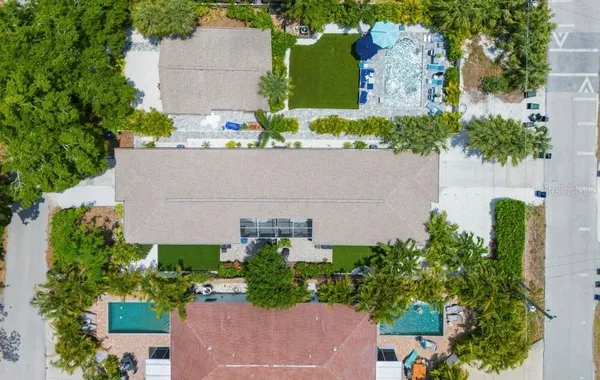 an aerial view of a house with a yard and garden