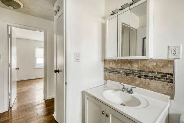 a bathroom with a sink and a mirror