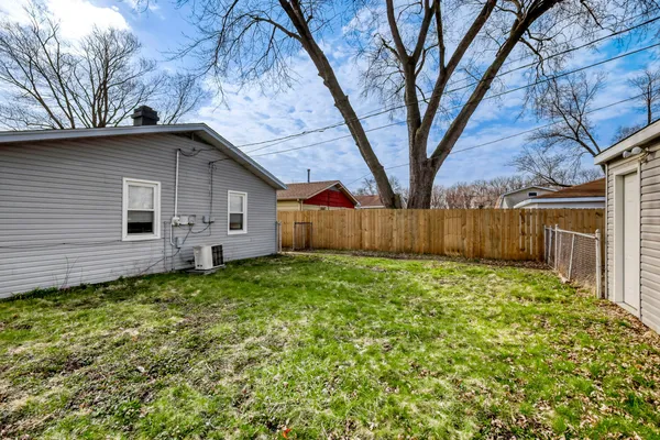 a view of a backyard with large tree