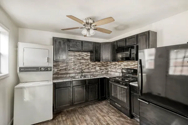 a kitchen with stainless steel appliances a sink cabinets and refrigerator