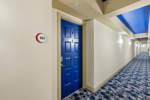a view of a hallway with wooden floor