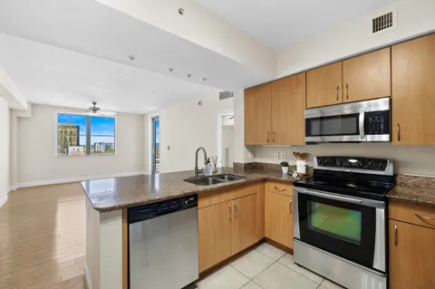 a kitchen with stainless steel appliances a stove sink microwave and cabinets
