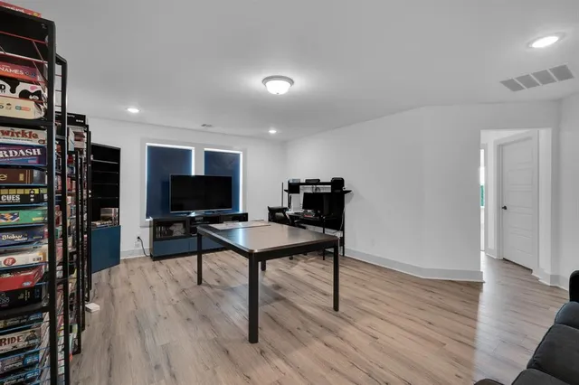 a living room with furniture a flat screen tv and a table