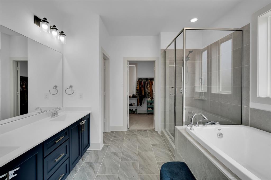 10912 Rochelle Court Grand Prairie, TX 76065 - Photo 5 of 30 a spacious bathroom with a tub sink shower and mirror