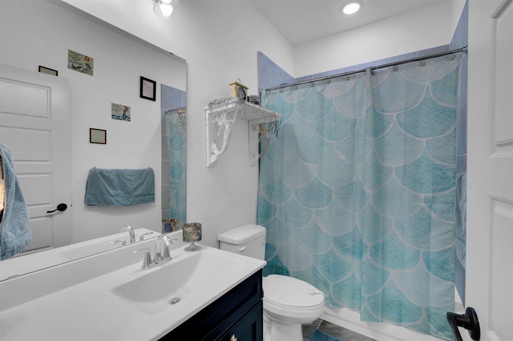 10912 Rochelle Court Grand Prairie, TX 76065 - Photo 10 of 30 a bathroom with a sink a toilet and shower