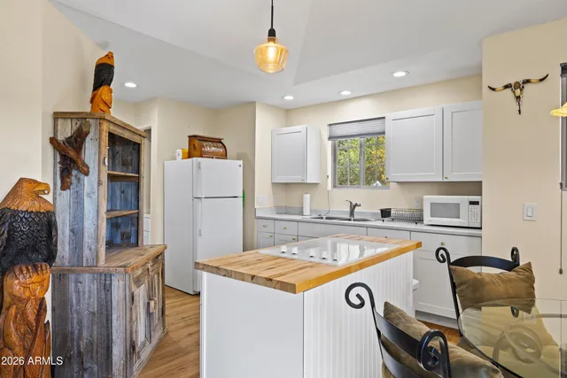 a view of kitchen island with furniture and wooden floor