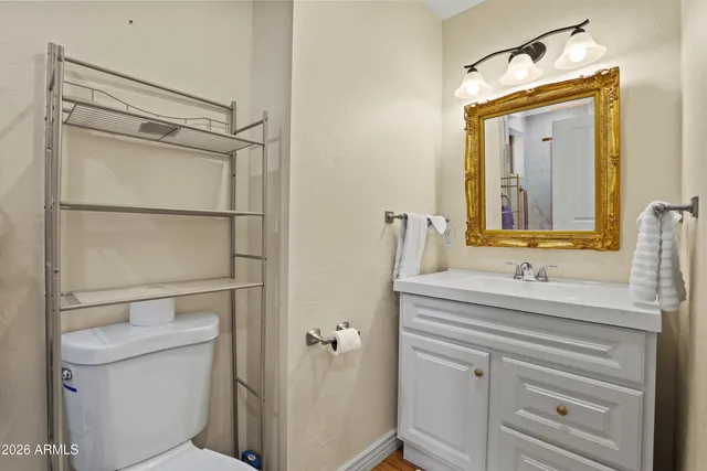 a bathroom with a toilet a sink and a mirror