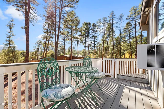 a view of a balcony with wooden floor and bench