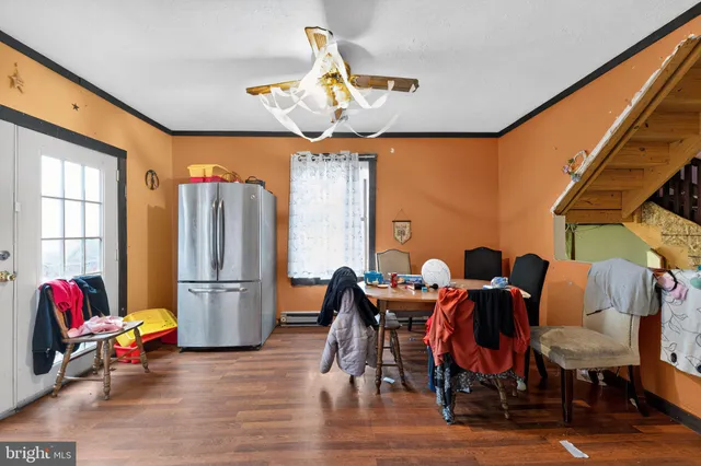 a view of dining room with furniture wooden floor and chandelier