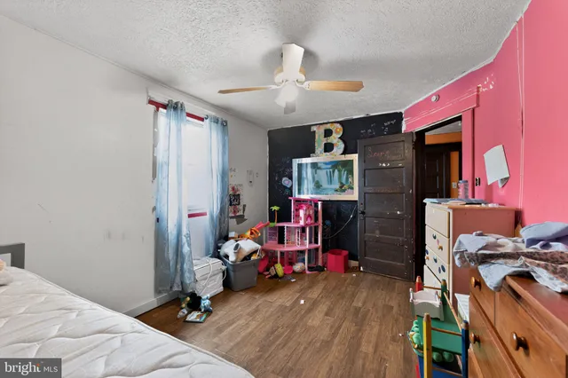 a bedroom with bed and a tv