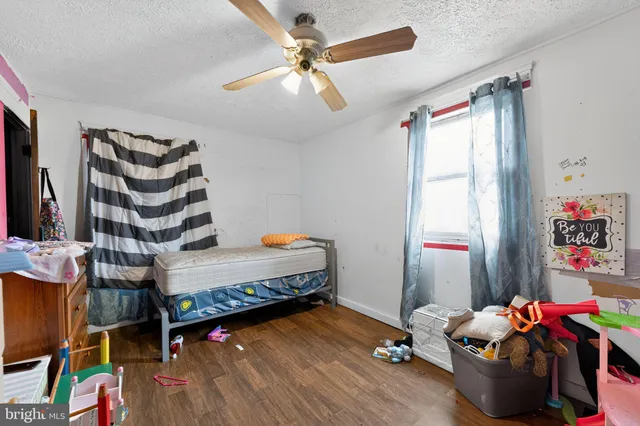 a bedroom with furniture and a wooden floor