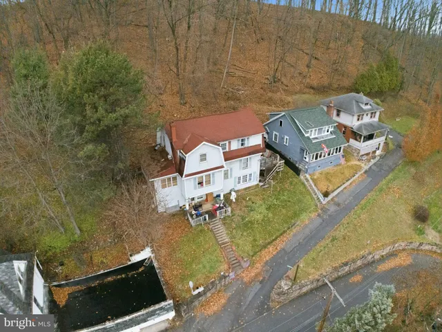 an aerial view of a house with a ocean view