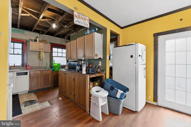 a kitchen with refrigerator and window