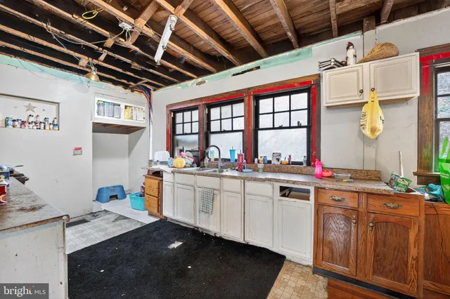 a kitchen with sink stove and cabinets