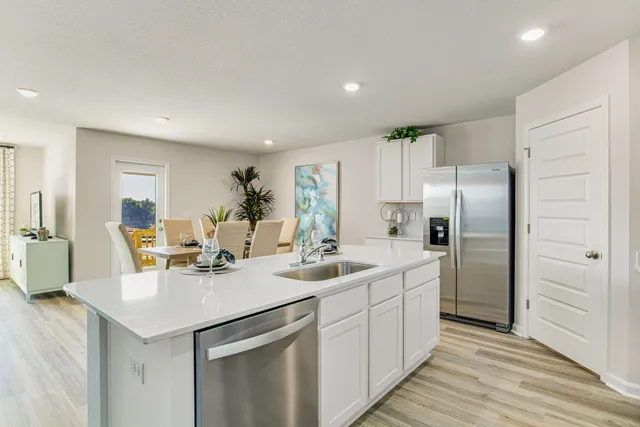a kitchen with a sink appliances and cabinets