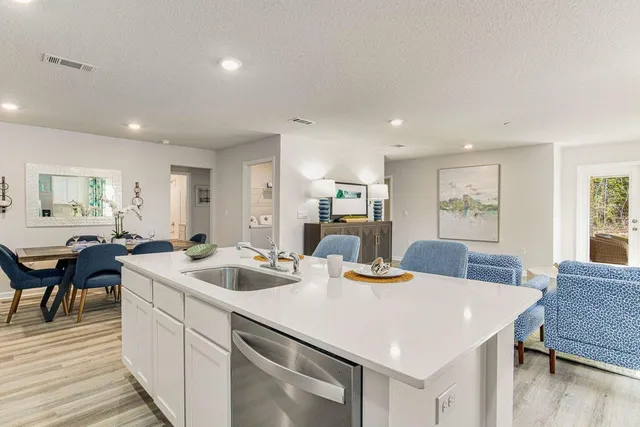 a view of kitchen island a sink and living room