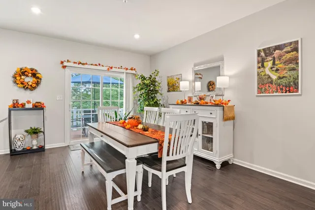 a dining room with furniture and wooden floor