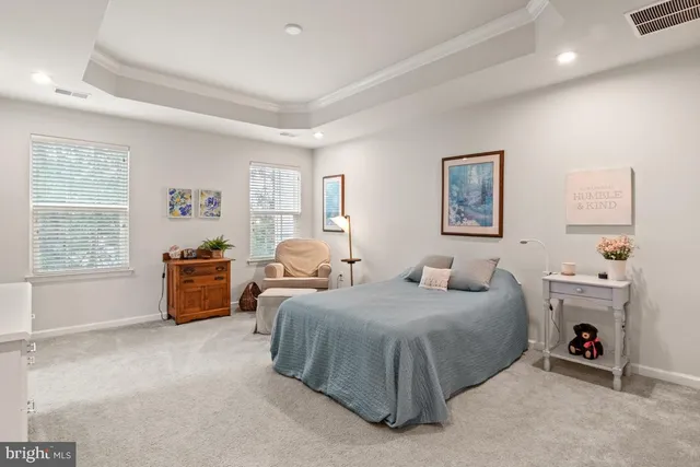 a spacious bedroom with a bed and a couch