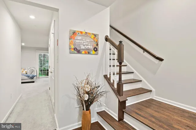 a view of entryway with wooden floor and stairs