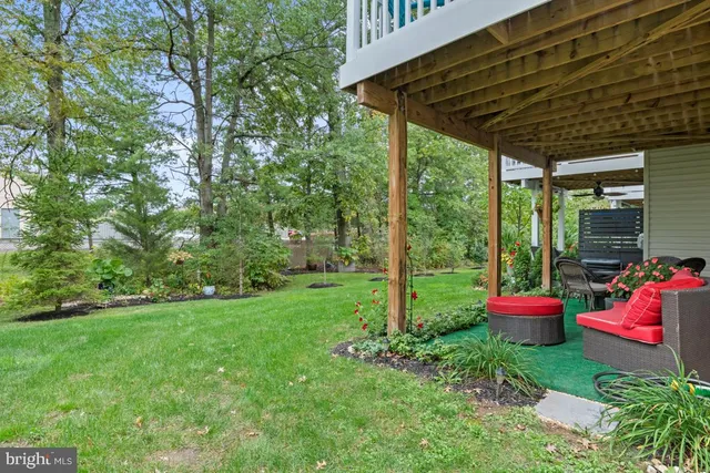 a view of a backyard with table and chairs and potted plants